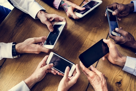 People hands using smartphone in a meeting