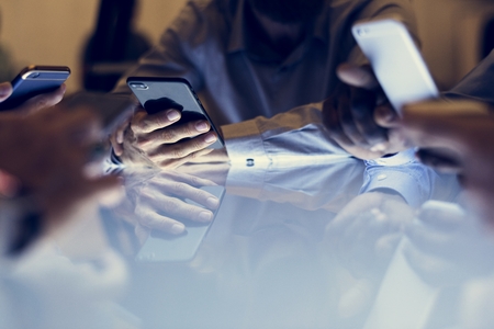 Hand holding smartphone sitting together