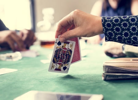 Adults socialising and playing cards