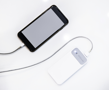 Smartphone being charged using a power bank
