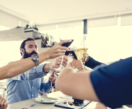 People cheers a wine glasses together