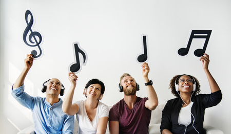 People holding musical icons