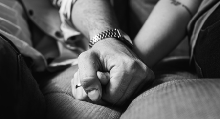 Closeup of couple holding hands