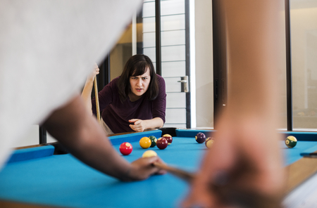 Rivalry couple playing a game of pool
