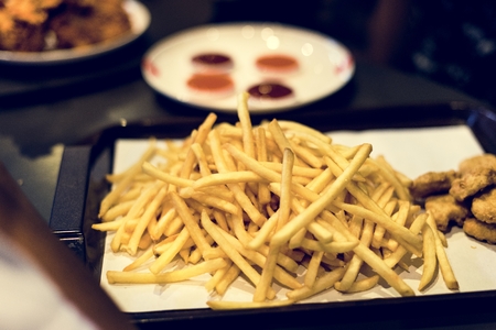 Tray of junk food fast food chicken nuggets and french fries