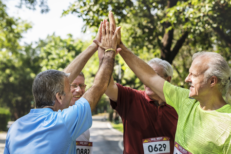 Group of senior athletes giving a high five