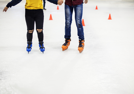 Group of teenage friends ice skating on an ice rink