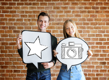 Young couple holding social media icons