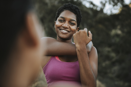 Active woman stretching together outdoors