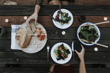 Foto per Salad and bread on a wooden table - Immagine Royalty Free