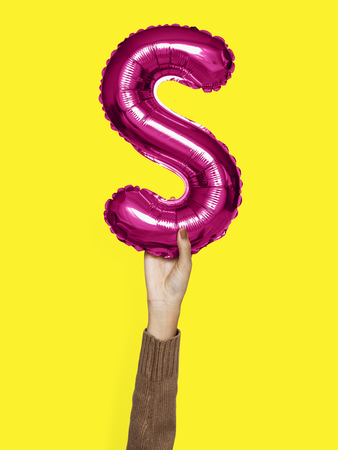 Hand holding balloon letter S
