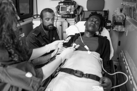 Paramedics providing first aid to a patient