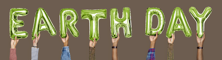 Hands showing earth day balloons word