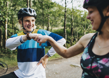 Cyclists giving each other a fist bump