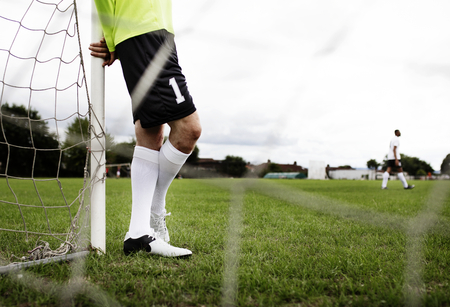 Male goalkeeper standing by the goal