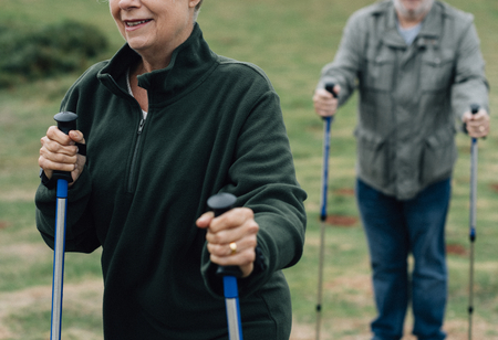 Active seniors with trekking poles