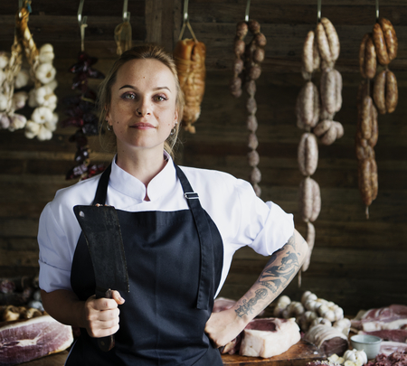 Female butcher selling meat in a butcher shop food photography recipe idea