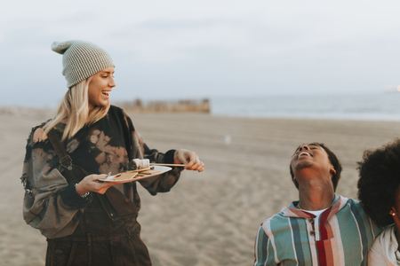 Friends having s'mores at the beach