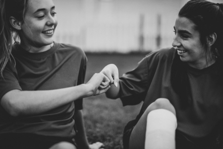 Happy female rugby players doing a fist bump