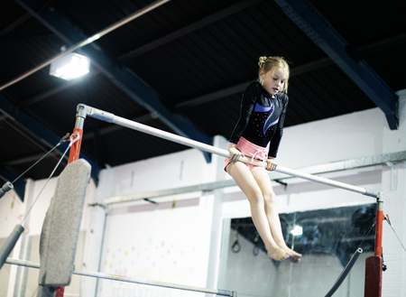 Young gymnast on a horizontal bar