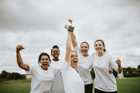 Cheerful female football players celebrating their victory