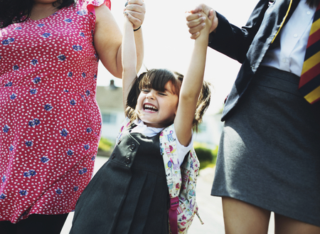 Mother and daughters on the way to school
