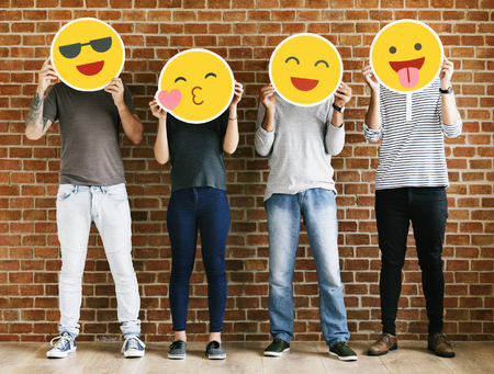 People holding positive emoticons