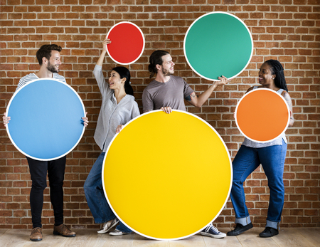 Diverse people holding colorful round boards
