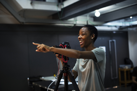 Cheerful photographer giving instructions in the studio