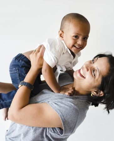 Mother holding son with happiness