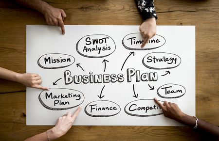 Fingers pointing at a business plan