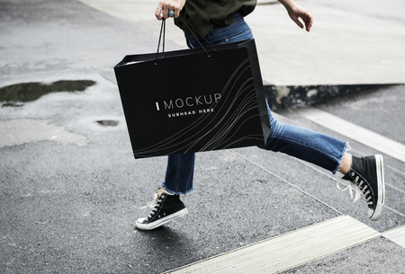 Woman carrying a shopping bag mockup