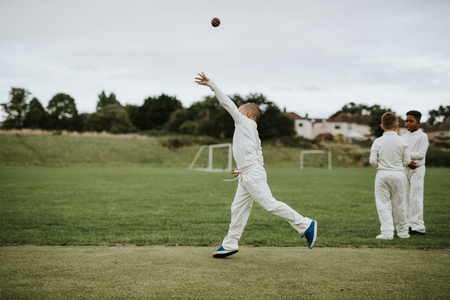 Cricket player catching a ball