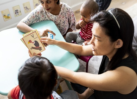 Young children learning the English alphabet with their parents