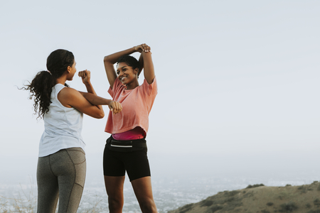 Friends stretching together while on a hike