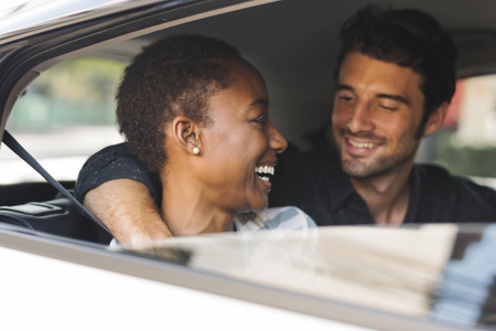 Happy couple transporting via a car