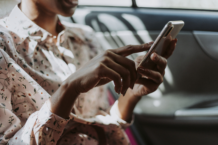 Woman using phone in a car