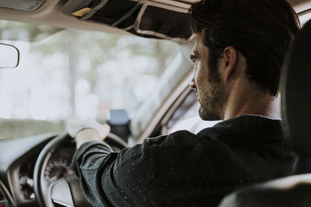 A man driver sitting in the car
