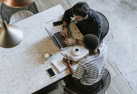 Colleagues discussing their work on a laptop