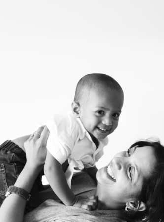 Mother holding son with happiness