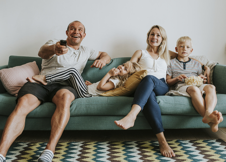 Family watching TV on the couch