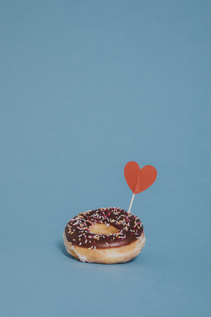 Tasty glazed donut decorated with a heart