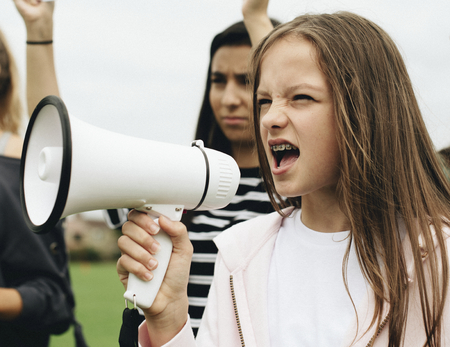 Female activist shouting on a megaphone