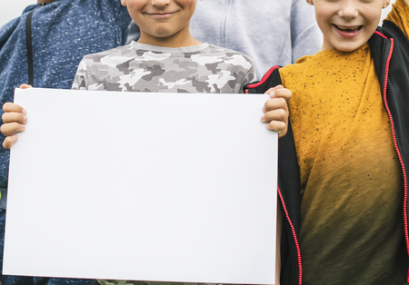 Group of young boys showing blank papers