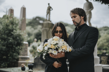 Couple grieving their loss at the cemetery