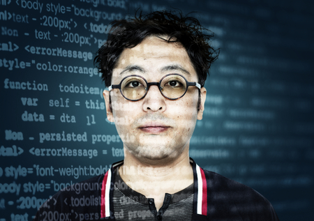 Asian hacker with computer code on his glasses