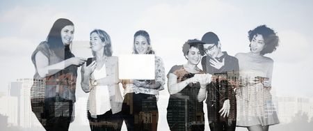 Group of diverse women using various digital devices
