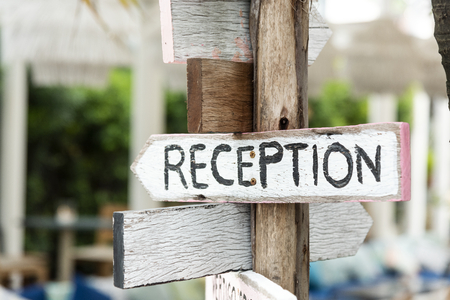 Wooden direction signage to reception