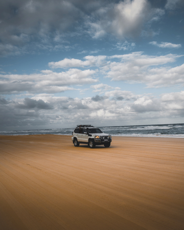 White SUV driving on the coast