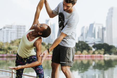 Couple doing a yoga in a park